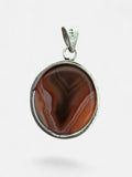 Making Waves Jewelry and Accessories handcrafted agate pendant with swirling terracotta and amber in sterling silver