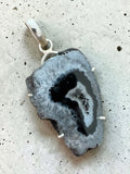 Making Waves Jewelry and Accessories agate slice pendant in charcoal and white with a 925 sterling silver setting.