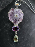 Making Waves Jewelry and Accessories statement necklace with raw amethyst flower, oval amethyst, and green gemstone drop.