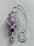 Making Waves Jewelry and Accessories statement necklace with raw amethyst flower, oval amethyst, and green gemstone.