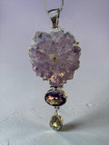 Making Waves Jewelry and Accessories statement necklace with raw amethyst flower, oval amethyst, and green gemstone.