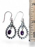 Making Waves Jewelry and Accessories sterling silver dangle earrings with leaf filigree frames and amethyst gemstones.