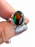 Making Waves Jewelry and Accessories oval ammolite ring in sterling silver with etched bezel and iridescent gemstone.