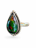 Making Waves Jewelry and Accessories teardrop Ammolite ring in sterling silver with rope detailing and bead accents.