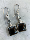 Making Waves Jewelry and Accessories sterling silver drop earrings with square and teardrop black onyx stones.