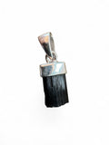 Making Waves Jewelry and Accessories raw black tourmaline crystal pendant with a polished silver-tone cap.