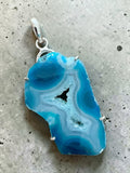 Making Waves Jewelry and Accessories blue agate geode slice pendant in a polished sterling silver setting.