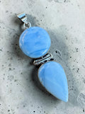 Making Waves Jewelry and Accessories double stone pendant featuring blue opal cabochons in a sterling silver setting.