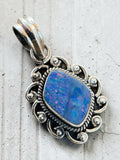 Making Waves Jewelry and Accessories blue opal pendant in a sterling silver frame with intricate scrollwork and rope trim
