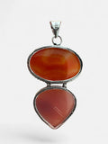 Making Waves Jewelry and Accessories sterling silver pendant featuring oval and teardrop carnelian stones with beaded edge