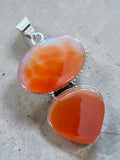 Making Waves Jewelry and Accessories sterling silver pendant with oval and teardrop carnelian stones and beaded edges.