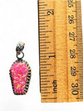 Making Waves Jewelry and Accessories coffin pendant with neon pink opal in oxidized sterling silver next to a ruler