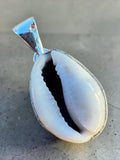 Making Waves Jewelry and Accessories cowrie shell pendant with a polished silver setting for a coastal bohemian look.