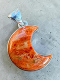 Making Waves Jewelry and Accessories crescent moon pendant featuring a marbled orange gemstone in sterling silver