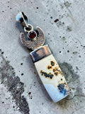 Making Waves Jewelry and Accessories crescent moon pendant featuring dendritic agate, red garnet, and 925 sterling silver.