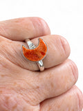 Making Waves Jewelry and Accessories sterling silver ring featuring a textured orange crescent moon stone on a finger
