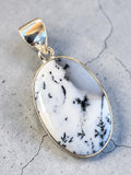 Making Waves Jewelry and Accessories dendritic agate oval pendant with fern-like inclusions in a sterling silver bezel.