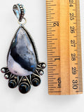 Making Waves Jewelry and Accessories teardrop dendritic opal pendant in sterling silver with black onyx accents.