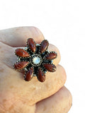 Making Waves Jewelry and Accessories floral statement ring with red jasper teardrop stones and a central white stone.