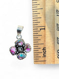 Making Waves Jewelry and Accessories sterling silver floral pendant with pink, purple, and turquoise stones by a ruler.