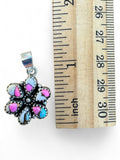 Making Waves Jewelry and Accessories sterling silver floral pendant with pink, white, and turquoise stone inlay.