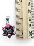 Making Waves Jewelry and Accessories floral pendant with pink marbled stones in oxidized sterling silver next to ruler