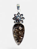 Making Waves Jewelry and Accessories teardrop fossil coral pendant with a silver floral bail and earthy stone patterns.