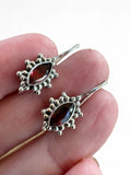 Making Waves Jewelry and Accessories garnet drop earrings with marquise-cut stones and beaded sterling silver borders.