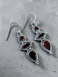 Making Waves Jewelry and Accessories sterling silver drop earrings with tiered red garnet gemstones and rope detailing.