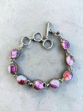 Making Waves Jewelry and Accessories handcrafted sterling silver bracelet with multi-colored pink gemstone cabochons