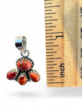 Making Waves Jewelry and Accessories sterling silver pendant with red and orange gemstones next to a ruler