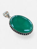 Making Waves Jewelry and Accessories oval green onyx pendant in a sterling silver beaded frame on a white background.