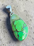 Making Waves Jewelry and Accessories handcrafted green turquoise pendant in a polished 925 sterling silver setting.