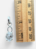 Making Waves Jewelry and Accessories raw Herkimer diamond crystal pendant in a sterling silver setting next to a ruler