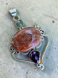 Making Waves Jewelry and Accessories artisan pendant with oval jasper, purple amethyst, and sterling silver filigree.