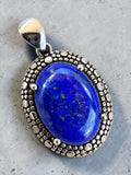Making Waves Jewelry and Accessories oval lapis lazuli pendant in 925 sterling silver with a beaded textured frame