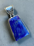 Making Waves Jewelry and Accessories handcrafted Lapis Lazuli pendant in sterling silver with filigree bail detail.