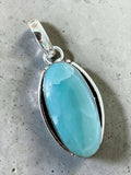 Making Waves Jewelry and Accessories oval Larimar pendant in polished 925 sterling silver with blue gemstone patterns