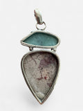 Making Waves Jewelry and Accessories artisan pendant featuring sky-blue Larimar and pink Rhodonite in sterling silver.