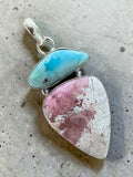 Making Waves Jewelry and Accessories artisan pendant featuring sky-blue Larimar and pink Rhodonite in sterling silver.