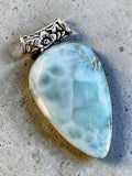 Making Waves Jewelry and Accessories teardrop Larimar pendant with a decorative silver-tone floral filigree bail.