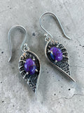 Making Waves Jewelry and Accessories sterling silver dangle earrings with purple oval stones in leaf-shaped settings.