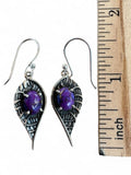 Making Waves Jewelry and Accessories sterling silver leaf dangle earrings with purple oval stones next to a ruler