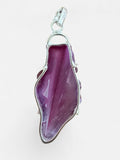 Making Waves Jewelry and Accessories magenta agate slice pendant in a polished sterling silver setting.