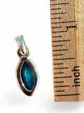Making Waves Jewelry and Accessories marquise-cut blue opal pendant next to a ruler for size reference.