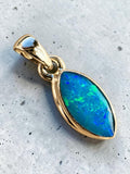 Making Waves Jewelry and Accessories marquise-cut opal pendant with blue and green flashes in a polished gold setting.