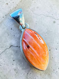 Making Waves Jewelry and Accessories marquise spiny oyster shell pendant in a polished sterling silver bezel setting