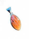 Making Waves Jewelry and Accessories marquise spiny oyster shell pendant in a polished sterling silver bezel setting.