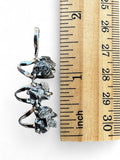 Making Waves Jewelry and Accessories triple meteorite pendant with raw dark stones in a polished silver-tone setting