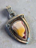 Making Waves Jewelry and Accessories artisan shield pendant featuring Mookaite Jasper set in oxidized sterling silver.